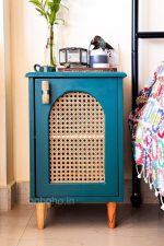 Teal side table with arched cane door panel and tapered wooden legs - goBoho